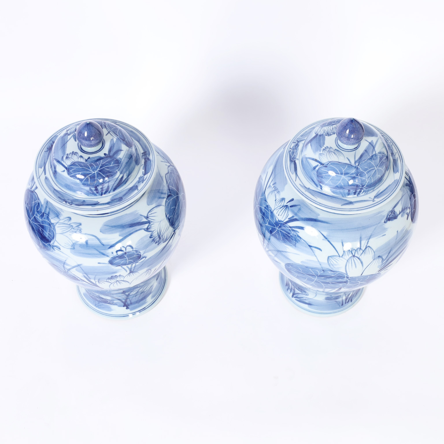 Pair of Chinese Blue and White Porcelain Lidded Urns with Lilies