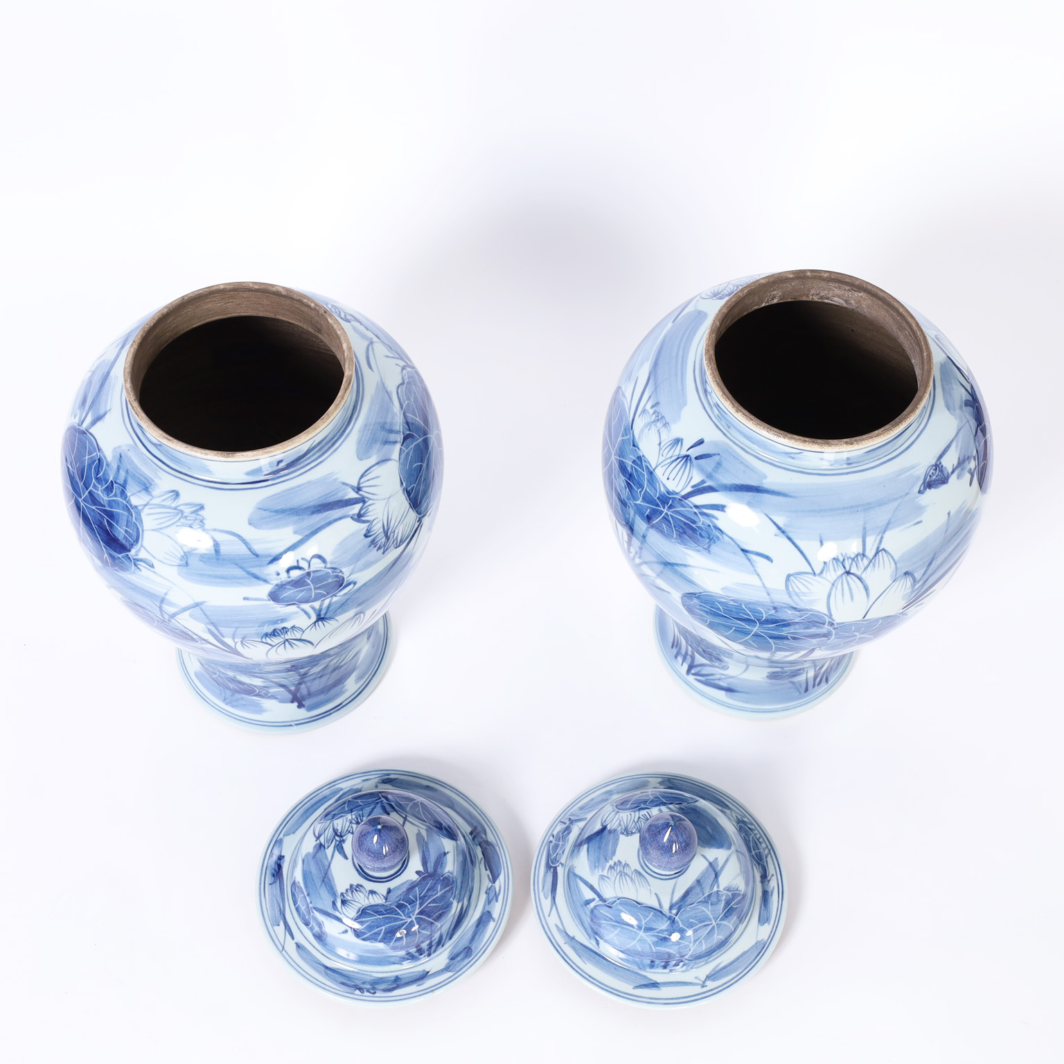 Pair of Chinese Blue and White Porcelain Lidded Urns with Lilies